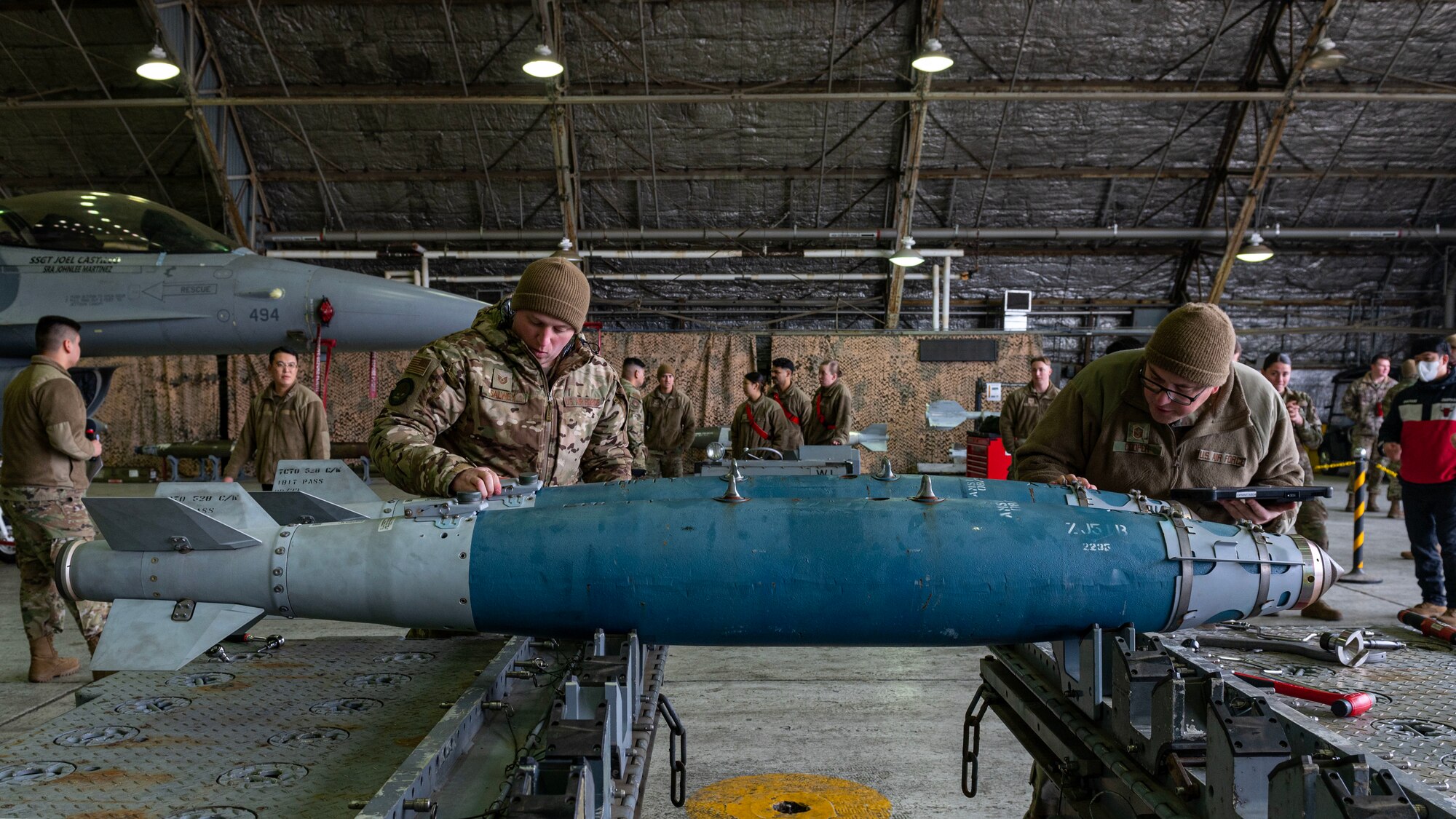 U.S. Air Force Tech. Sgt. Jacob Salwey, 51st Munitions Squadron conventional and maintenance production supervisor, and Master Sgt. Scott Cooper, 51st MUNS control section chief, conduct an inspection of two GBU-38 Joint Direct Attack Munition Bombs during a weapons load crew of the quarter competition at Osan Air Base, Republic of Korea, Jan. 5, 2024. As part of the competition, teams are evaluated on how quickly and efficiently they can inspect and load munitions onto their respective aircraft, along with safety, speed, reliability, technical errors and use of their checklist. (U.S. Air Force photo by Staff Sgt. Aubree Owens)