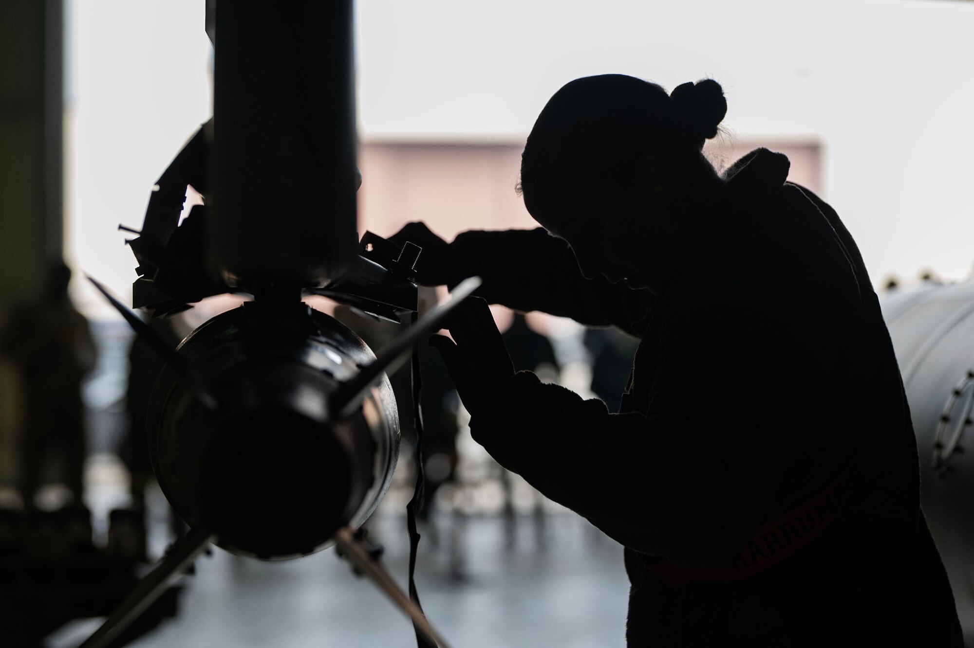 U.S. Air Force Senior Airman Erin Williamson, 36th Fighter Generation Squadron weapons load crew member, participates in a weapons load crew of the quarter competition at Osan Air Base, Republic of Korea, Jan. 5, 2024. Williamson was one of three members representing the 36th FGS team during the competition, where the event consisted of building and loading weapons onto an F-16 Fighting Falcon and A-10C Thunderbolt II aircraft. (U.S. Air Force photo by Staff Sgt. Aubree Owens)