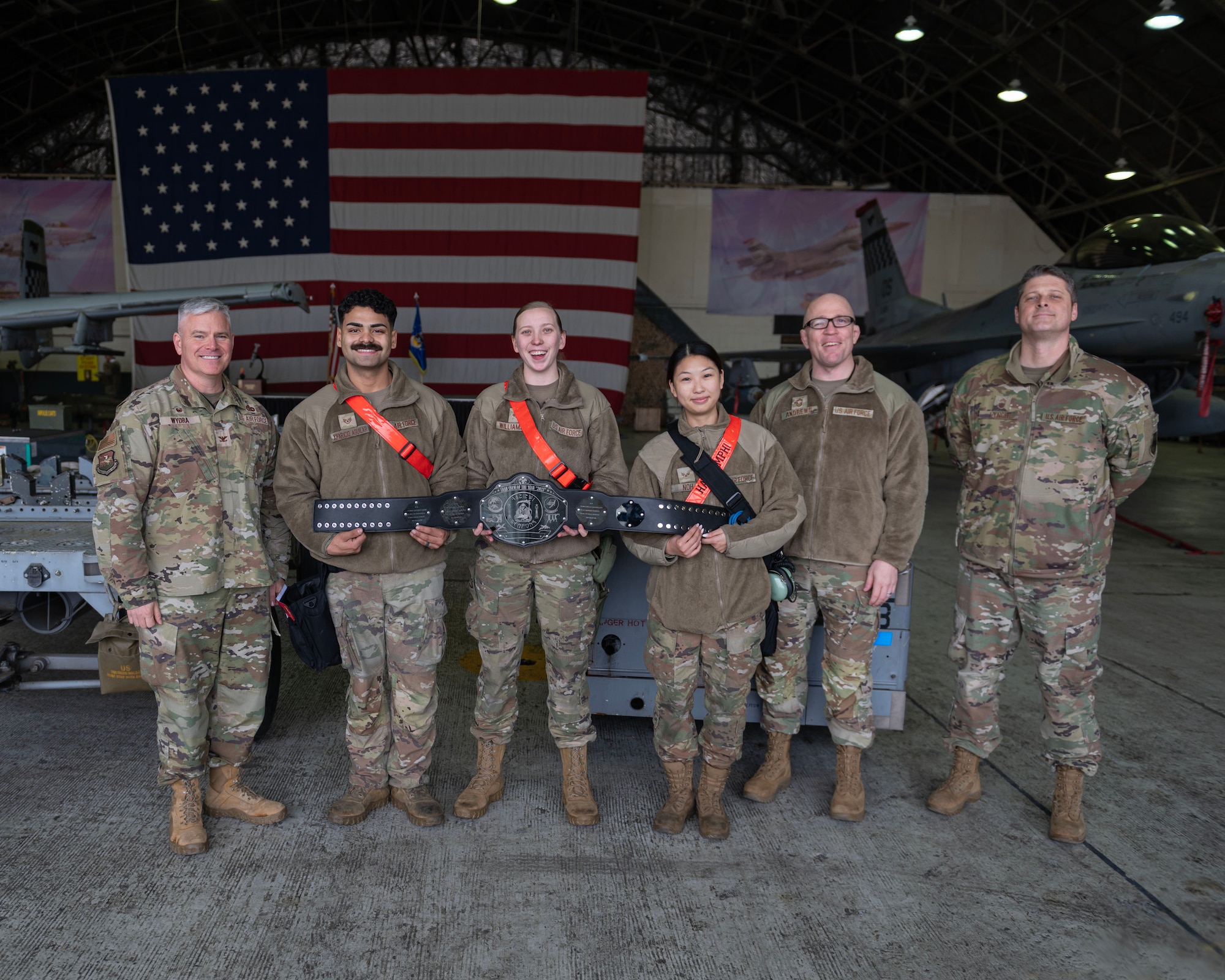 Leadership with the 51st Maintenance Group take a group photo with the load crew team with the 36th Fighter Generation Squadron during a weapons load crew of the quarter competition at Osan Air Base, Republic of Korea, Jan. 5, 2024. The competition is an opportunity to evaluate two load crews on their efficiency, teamwork, and attention to detail while loading munitions onto an F-16 Fighting Falcon and an A-10C Thunderbolt II. (U.S. Air Force photo by Staff Sgt. Aubree Owens)