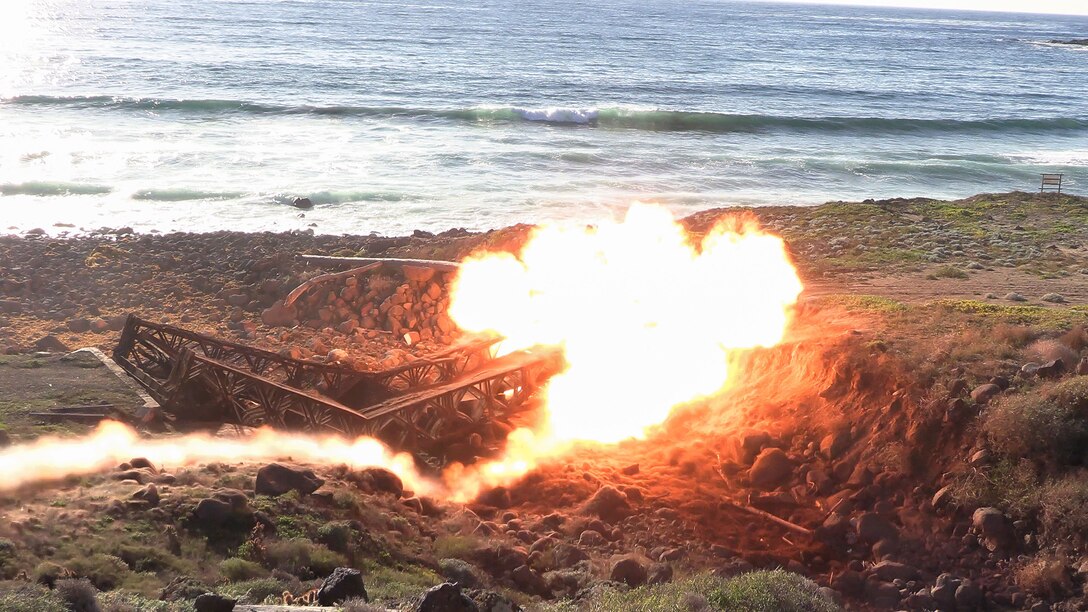 U.S. Marines with Marine Wing Support Squadron (MWSS) 373, Marine Air Control Group 38, 3rd Marine Aircraft Wing, detonate C4 to demolish the Bailey Bridge as part of phase I of Strategic Mobility Exercise (STRATMOBEX) II at San Clemente Island, California, Jan. 5, 2024. During phase I, MWSS-373 demolished a hazardous bridge that hindered range control’s ability to insert targets into the Shore Bombardment Area of San Clemente Island. Phase I set conditions for phases II and III of STRATMOBEX II, the construct of a shallow water crossing and follow on missions. (U.S. Marine Corps photo by Lance Cpl. Jennifer Sanchez)