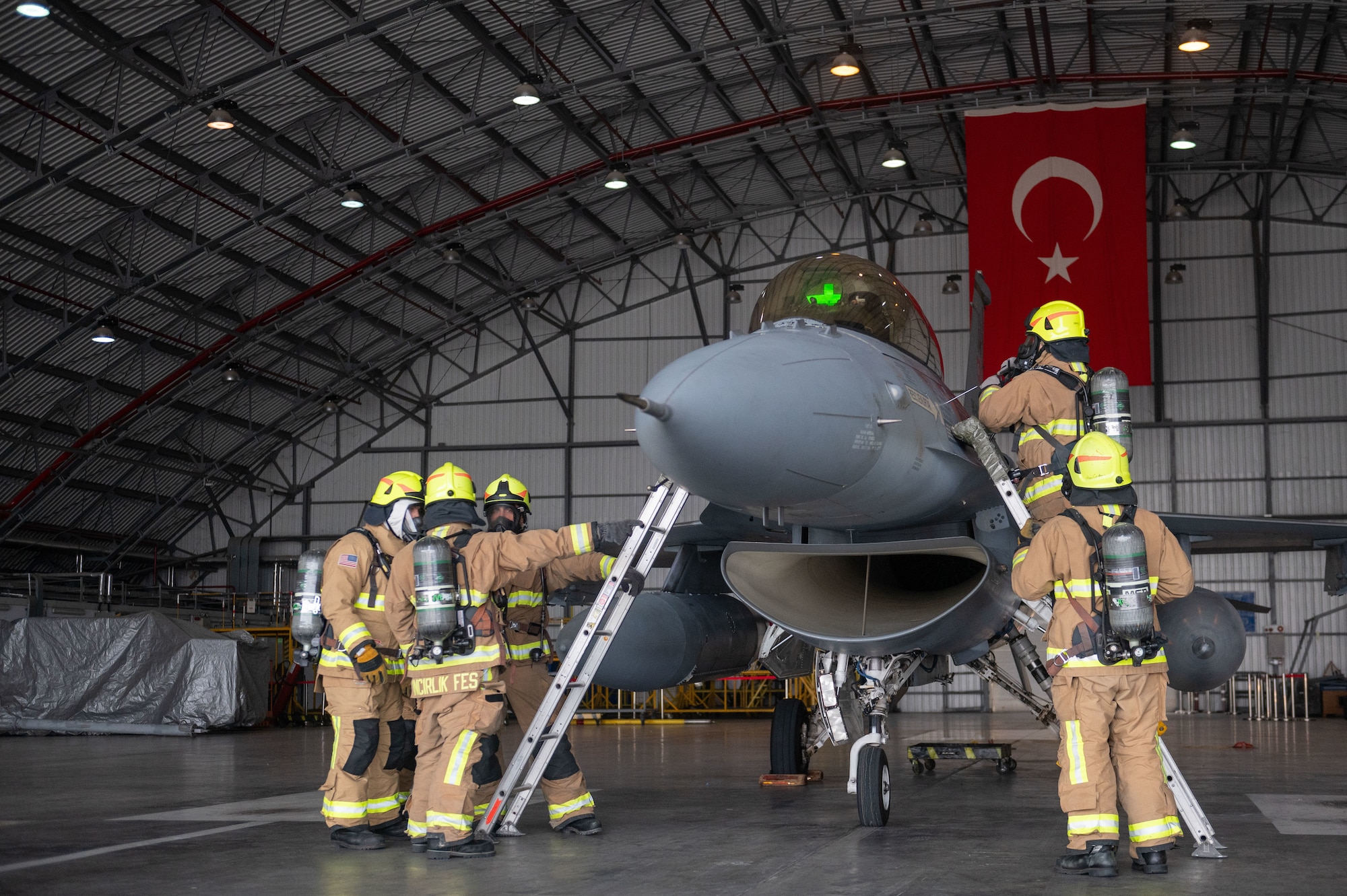 Firefighters assigned to the 39th Civil Engineer Squadron conduct a simulated unconscious pilot rescue operation during a crash, damaged, or disabled aircraft recovery (CDDAR) exercise at Incirlik Air Base, Türkiye, Jan. 8, 2024.