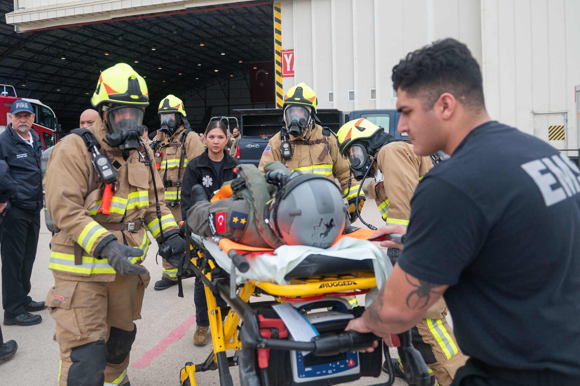 First responders from the 39th Medical Group and 39th Civil Engineer Squadron transport a simulated injured pilot during a crash, damaged, or disabled aircraft recovery (CDDAR) exercise at Incirlik Air Base, Türkiye, Jan. 8, 2024.