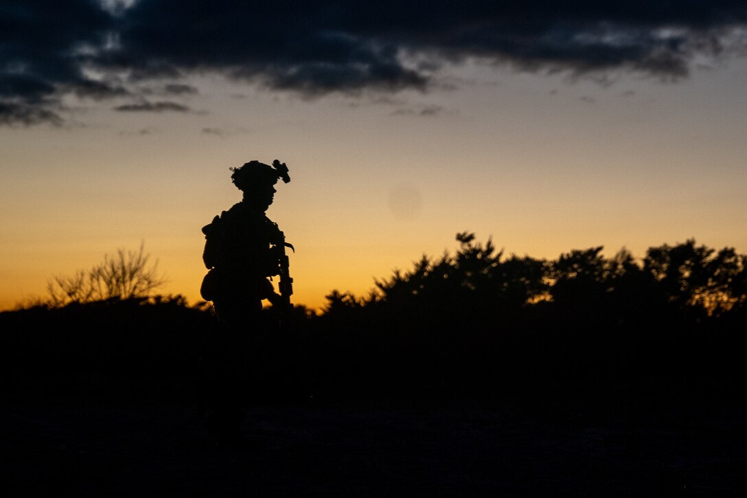 A U.S. Marine with Bravo Company, Battalion Landing Team 1/8, 24th Marine Expeditionary Unit, provides security for the simulated surface raid bivouac site during Amphibious Squadron, MEU Integration on Camp Lejeune, North Carolina, Dec. 12, 2023. PMINT is the 24th MEU’s first opportunity in the pre-deployment training cycle to fully integrate with the Wasp Amphibious Ready Group. During PMINT, the Marines and Sailors are tested across required operational capabilities and projected operating environments through a variety of simulated and live events.