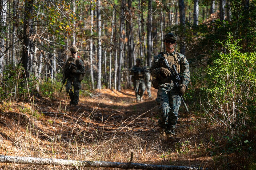 U.S. Marines with Bravo Company, Battalion Landing Team 1/8, 24th Marine Expeditionary Unit, patrol to the simulated surface raid objective during Amphibious Squadron, MEU Integration on Camp Lejeune, North Carolina, Dec. 12, 2023. PMINT is the 24th MEU’s first opportunity in the pre-deployment training cycle to fully integrate with the Wasp Amphibious Ready Group. During PMINT, the Marines and Sailors are tested across required operational capabilities and projected operating environments through a variety of simulated and live events.