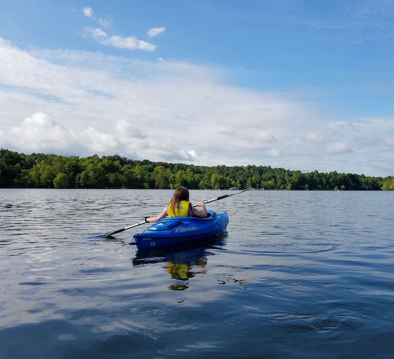 A girl kayaking on Rough River Lake in Falls of Rough, Kentucky.