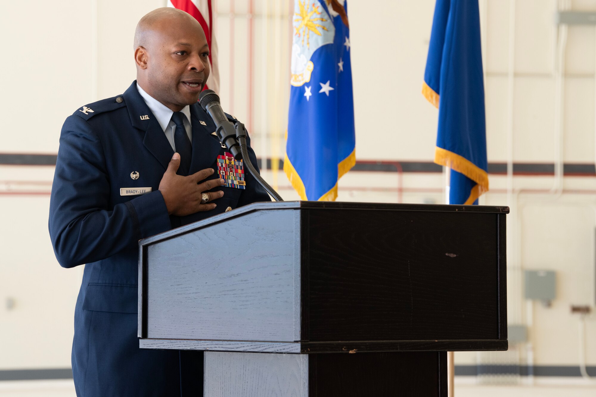 Maj. Gen. D. Scott Durham, 4th Air Force commander, passes the guidon to Col. Patrick L. Brady-Lee (right) as he assumes command of the 349th Air Mobility Wing on January 7, 2024, at Travis Air Force Base, California. (US Air Force photo by Tech. Sgt. Ryan Green)