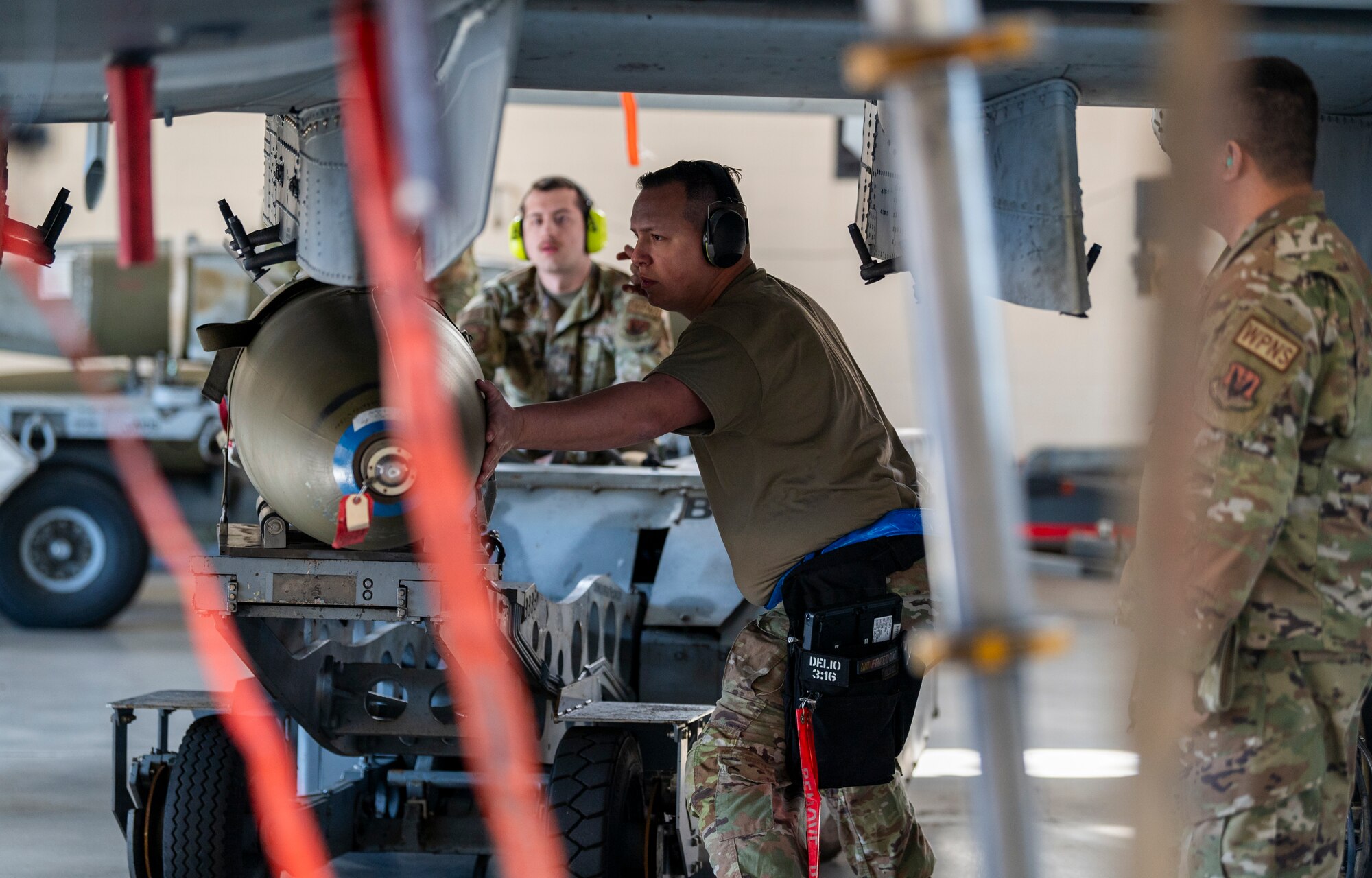 U.S. Air Force Staff Sgt. Concepcion Rodelo (front) and Airman 1st Class Aaron Bowie (back), 74th Fighter Generation Squadron load crew members, load munitions onto an A-10C Thunderbolt II at Moody Air Force Base, Georgia, Jan. 5, 2024. Improperly loading munitions can result in a mark down of points during the competition. (U.S. Air Force photo by Airman 1st Class Leonid Soubbotine)