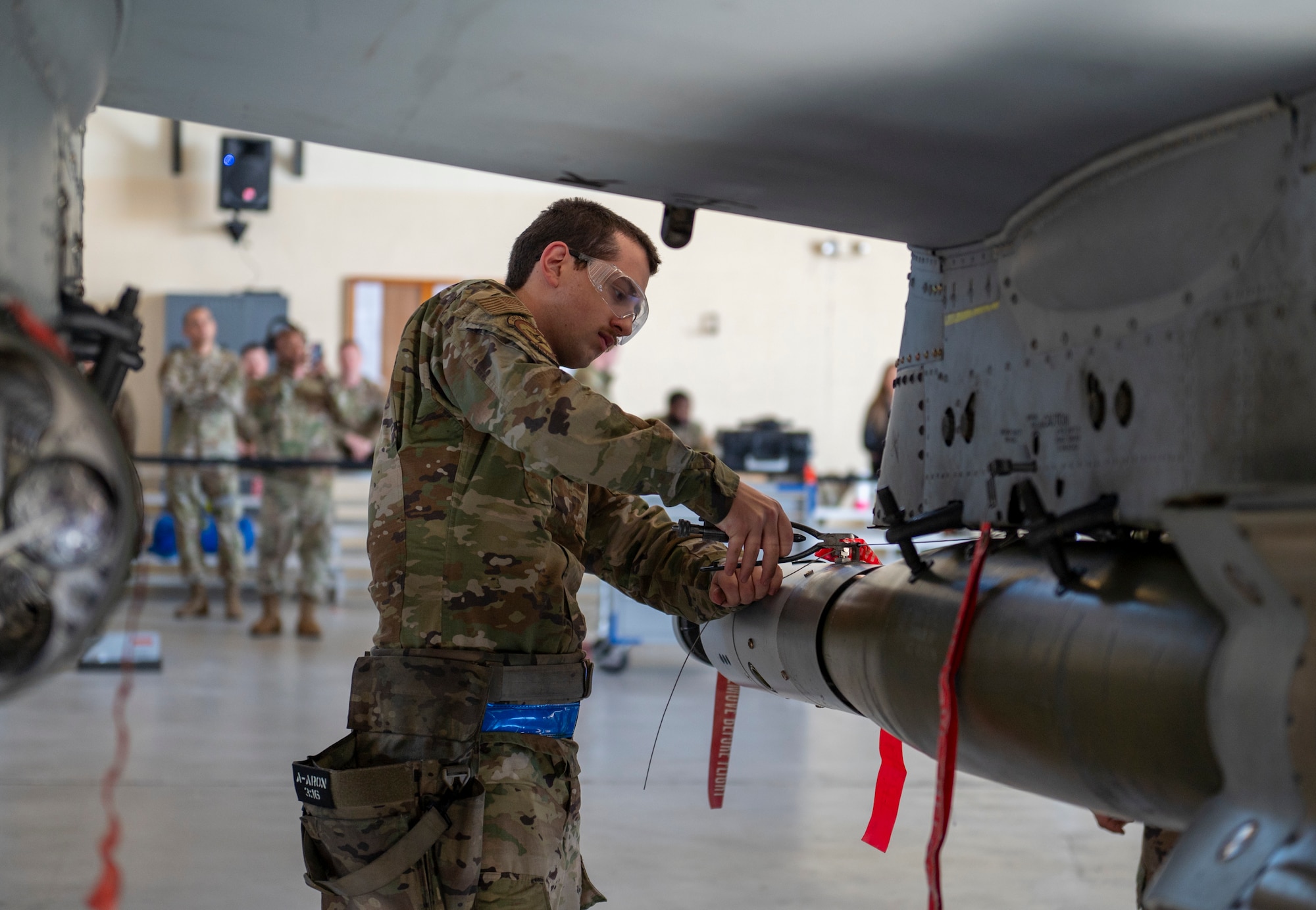 U.S. Air Force Airman 1st Class Aaron Bowie, 74th Fighter Generation Squadron load crew member, works on loading weapons on an A-10C Thunderbolt II at Moody Air Force Base, Georgia, Jan. 5, 2024. The weapon loading event was a competition between 74th and 75th Fighter Generation Squadron crews. (U.S. Air Force photo by Airman 1st Class Leonid Soubbotine)