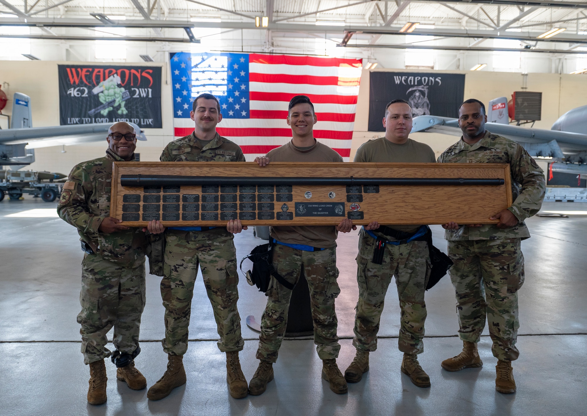 U.S. Air Force Airmen from the 74th Fighter Generation Squadron hold the quarterly load competition trophy at Moody Air Force Base, Georgia, Jan. 5, 2024. The 74th Fighter Generation Squadron team earned the title of winner for the fourth quarter competition. (U.S. Air Force photo by Airman 1st Class Leonid Soubbotine)