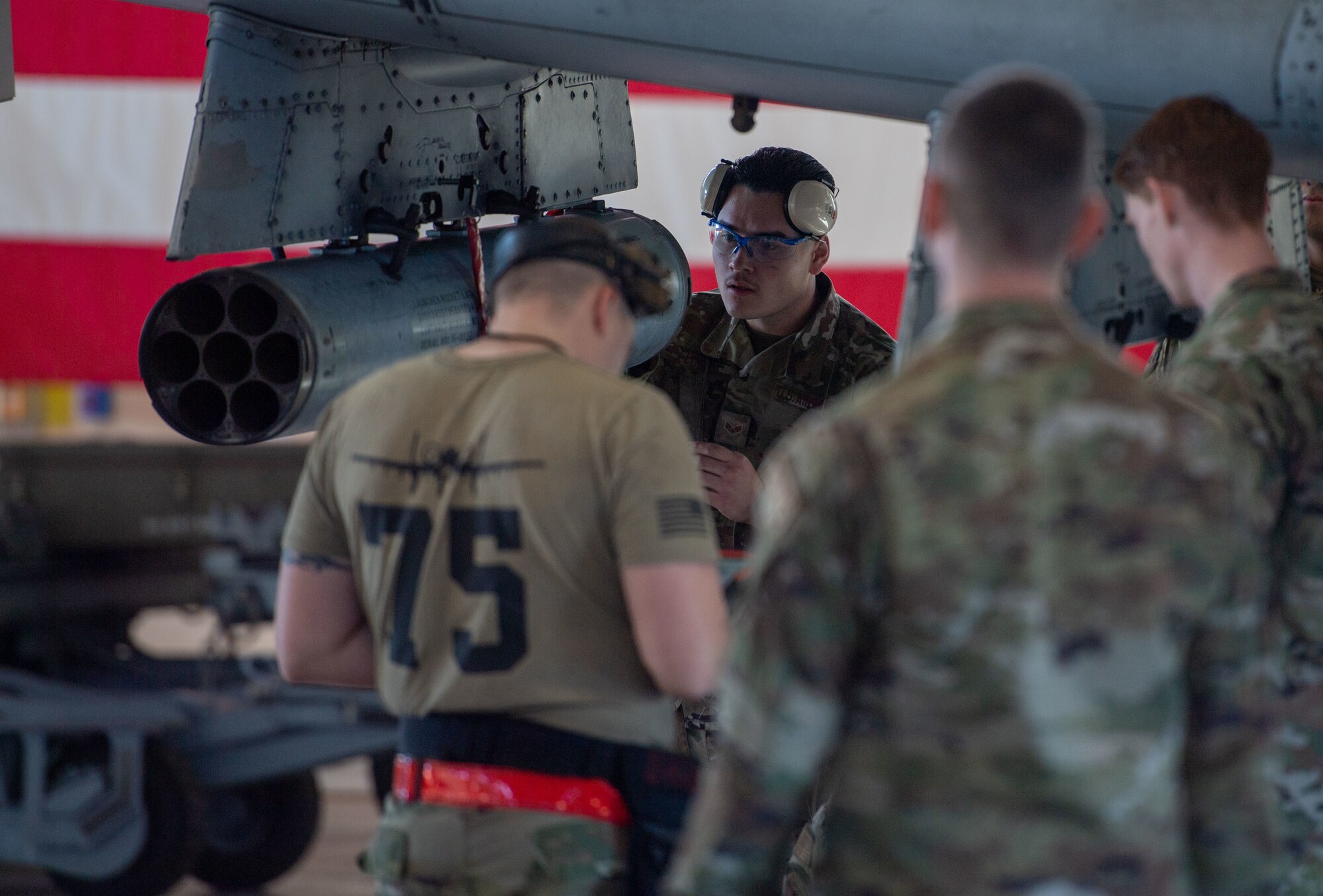 U.S. Air Force Airmen from the 75th Fighter Generation Squadron load crew work together to load an A-10C Thunderbolt II at Moody Air Force Base, Georgia, Jan 5, 2024. The 75th FGS competed in a quarterly weapons load crew competition against the 74th FGS. (U.S. Air Force photo by Airman Cade Ellis)