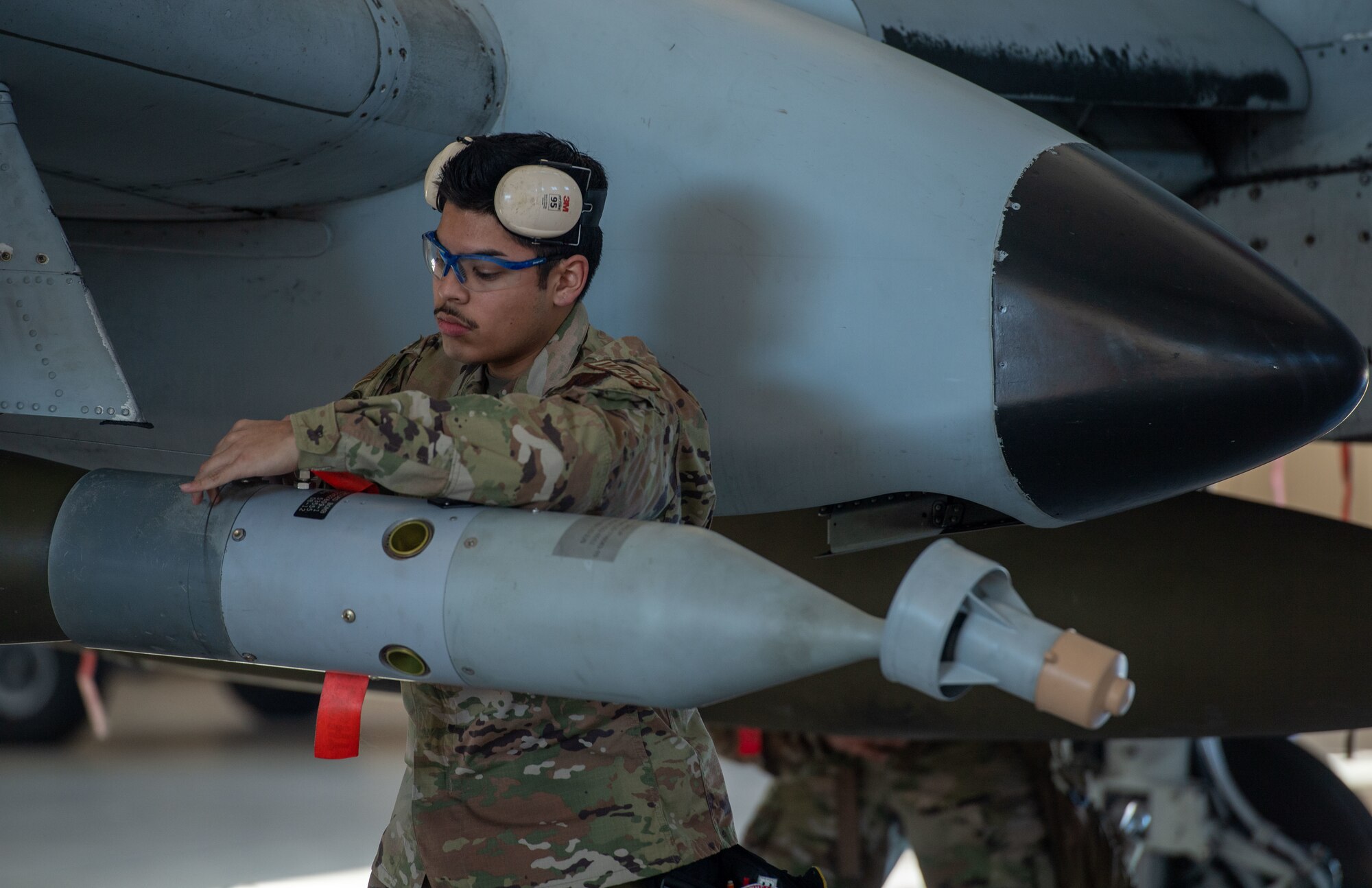U.S. Air Force Airman 1st Class Nicholas Martinez, 75th Fighter Generation Squadron load crew member, loads an A-10C Thunderbolt II at Moody Air Force Base, Georgia, Jan 5, 2024. During quarterly weapons load competitions, two squadrons face head-to-head loading weapons to aircraft with speed and accuracy. (U.S. Air Force photo by Airman Cade Ellis)