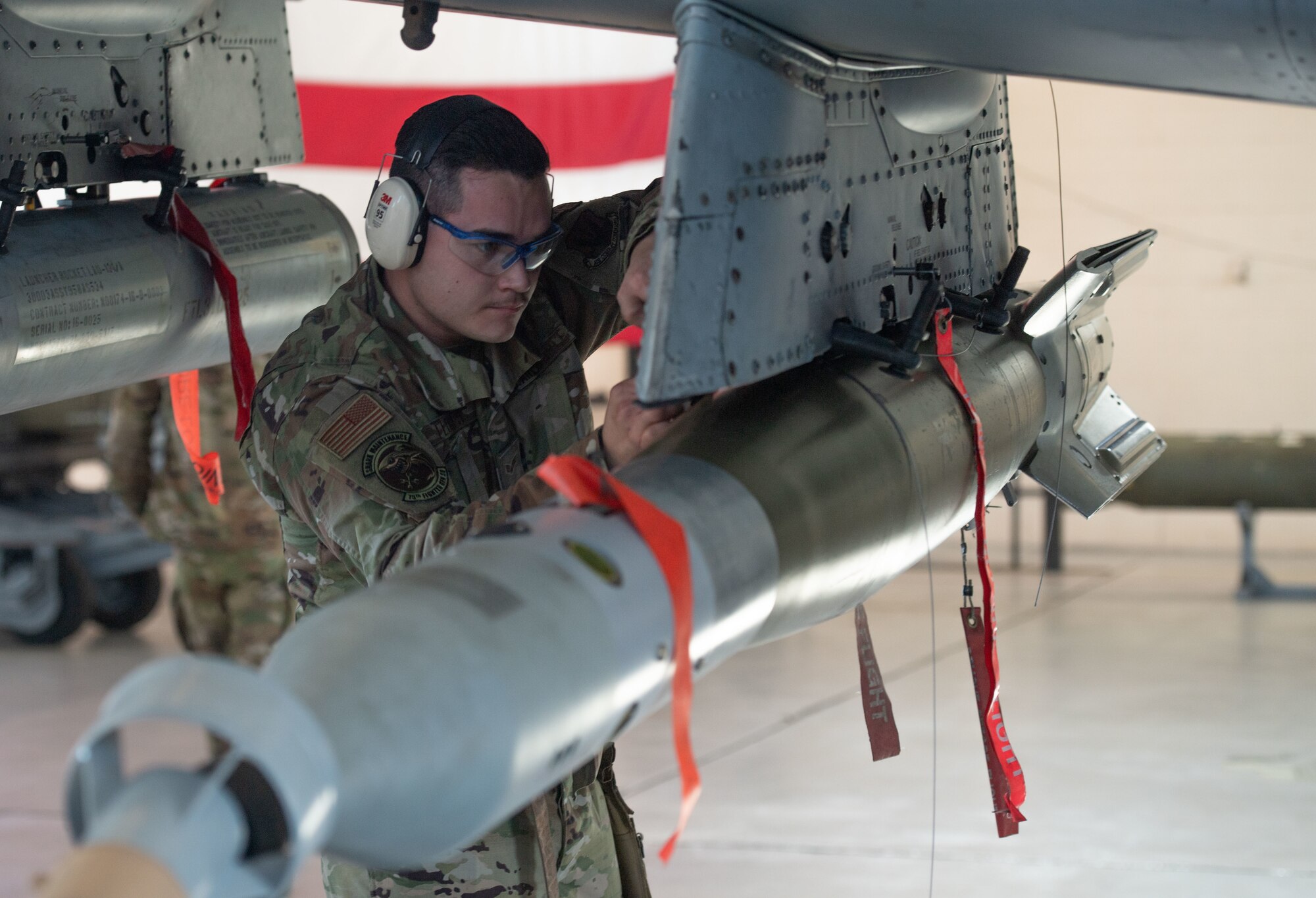 U.S. Air Force Senior Airman Mathew Flores, 75th Fighter Generation Squadron load crew member, loads an A-10C Thunderbolt II for a quarterly load competition at Moody Air Force Base, Georgia, Jan 5, 2024. The weapons load competitions are designed to show teamwork, speed and quality of work between the Airmen on each crew. (U.S. Air Force photo by Airman Cade Ellis)
