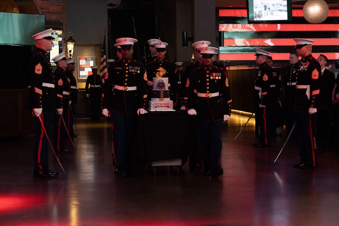 U.S. Marines with Recruiting Station St. Louis escort the birthday cake during a ceremony at Bally Sports Live, St. Louis, Missouri, Nov. 10, 2023. Marines from Recruiting Station St. Louis gathered to celebrate the Marine Corps' 248th birthday with a traditional birthday ball. (U.S. Marine Corps photo by Sgt. Cheyeanne Campbell)