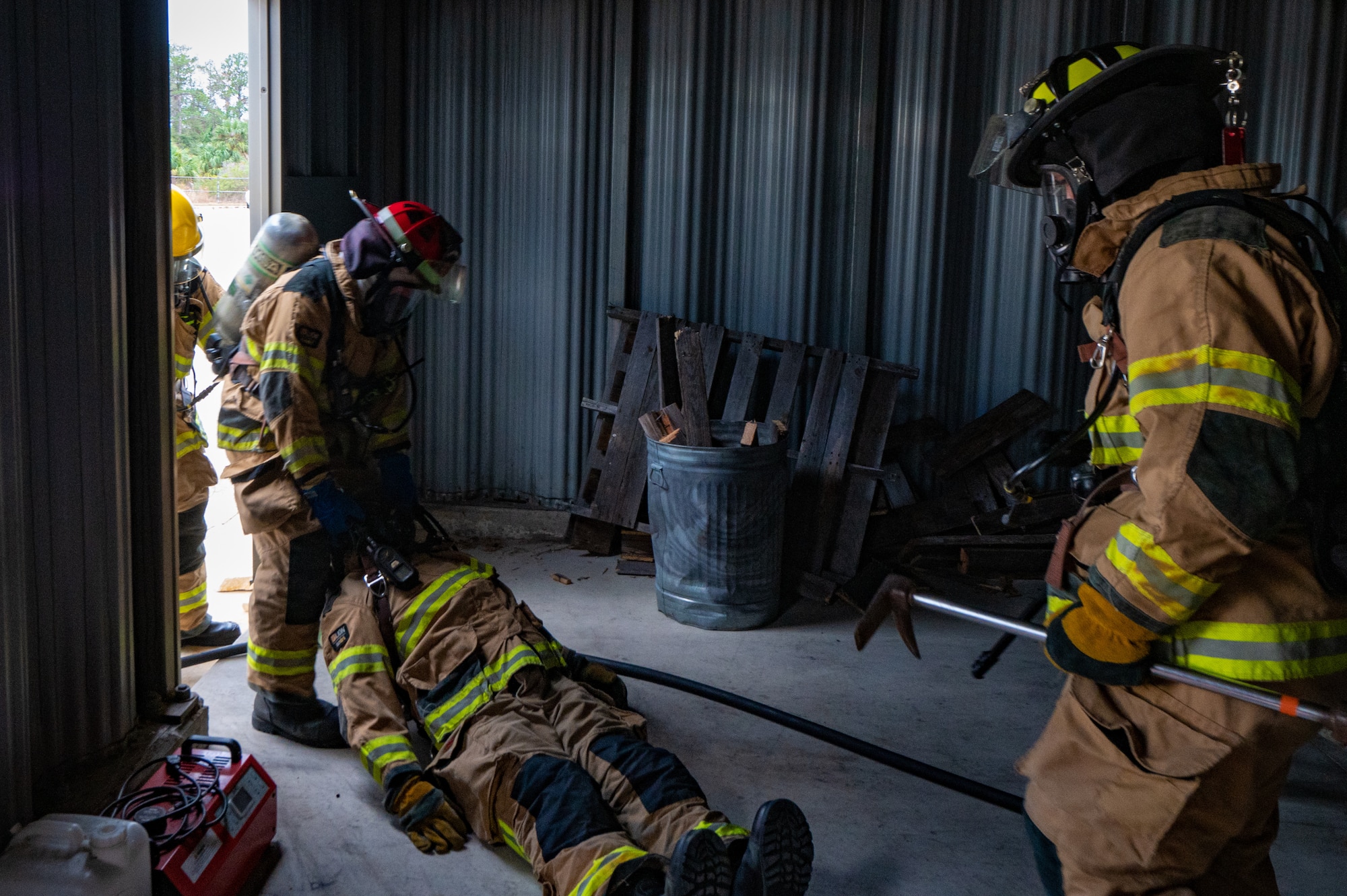 Firefighters assigned to the 6th Civil Engineering Squadron simulate rescuing a downed firefighter as part of rapid intervention training at MacDill Air Force Base, Florida, Jan. 11, 2024.