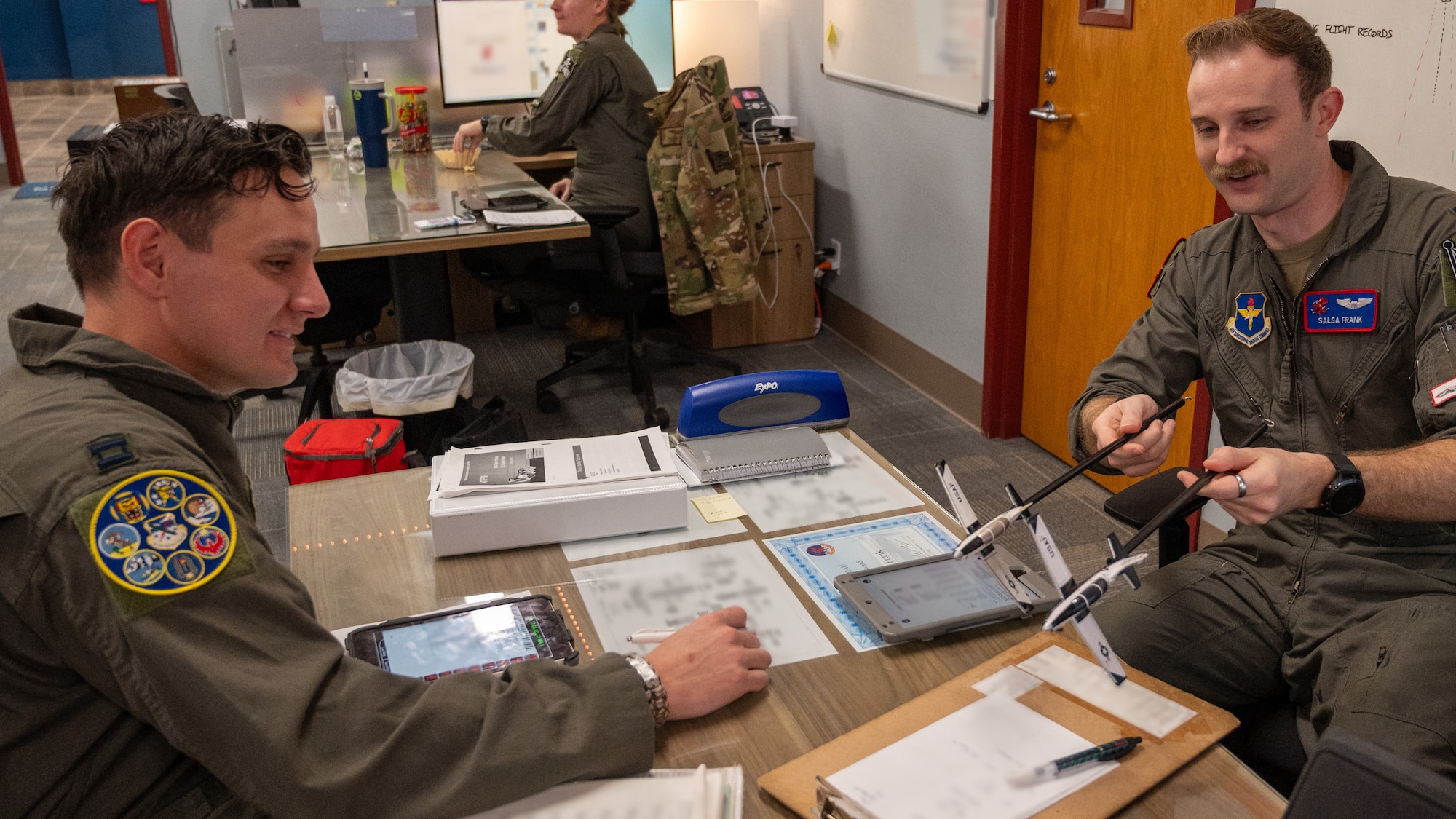 Roger Johnson (right), 47th Operations Group T-6A Texan II civilian simulator instructor, instructs 2nd Lt. Valerie Calvert, 47th Student Squadron student pilot, while flying in a simulator at Laughlin Air Force Base, Texas, Jan. 8, 2024. Strong mentorship helps develop student pilots, molding them into the next generation of aviators. Mentoring, at its core, is a partnership that facilitates the sharing of knowledge, experience and wisdom. (U.S. Air Force photo by Staff Sgt. Nicholas Larsen)