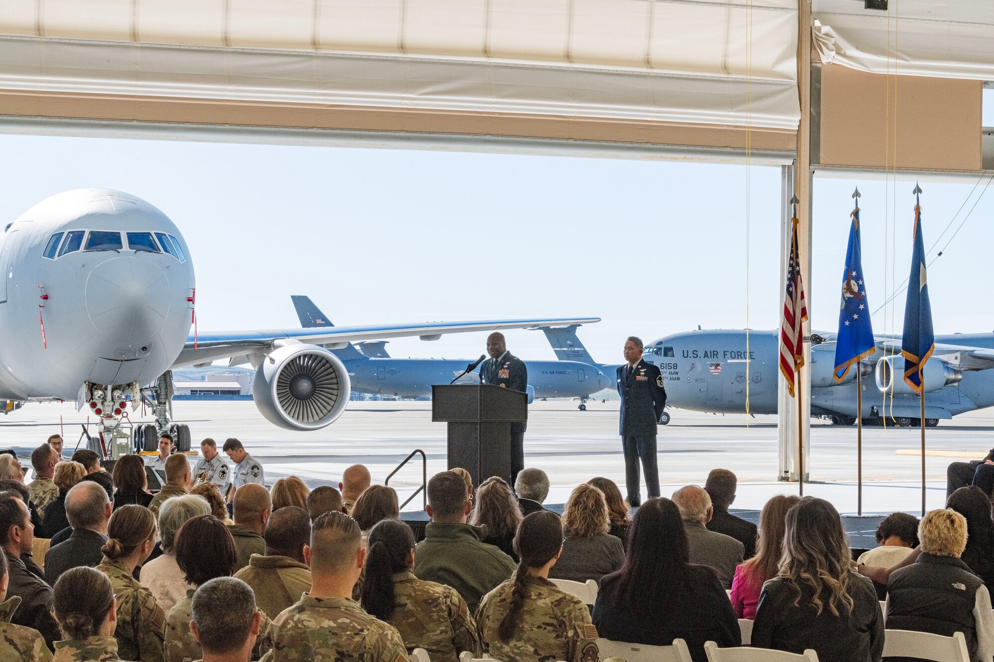 Maj. Gen. D. Scott Durham, 4th Air Force commander, passes the guidon to Col. Patrick L. Brady-Lee (right) as he assumes command of the 349th Air Mobility Wing on January 7, 2024, at Travis Air Force Base, California. (US Air Force photo by Tech. Sgt. Ryan Green)