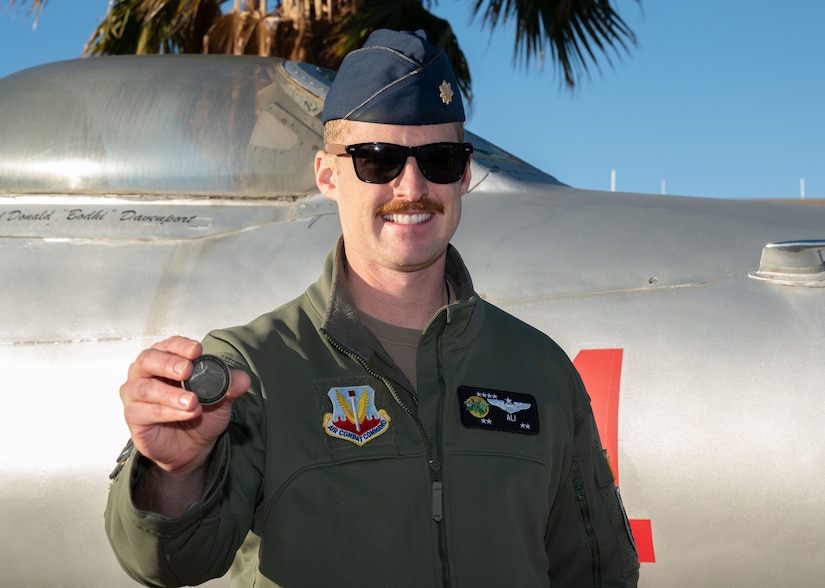 An airman poses for a photo.