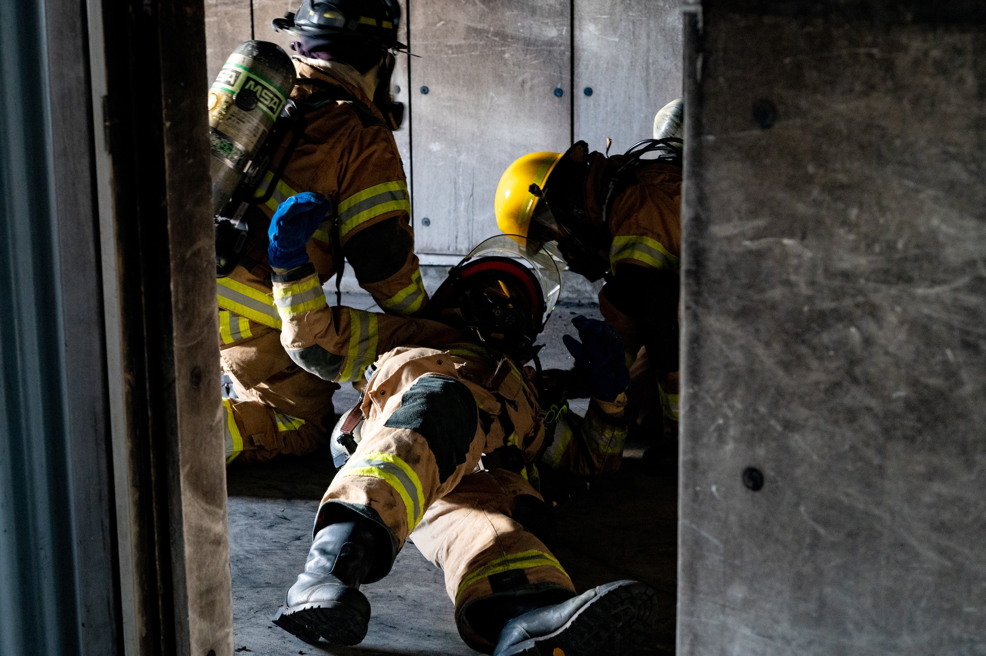 Firefighters from the 6th Civil Engineering Squadron  simulate rescuing a downed firefighter as part of  rapid intervention training at MacDill Air Force Base, Florida, Jan. 11, 2024.