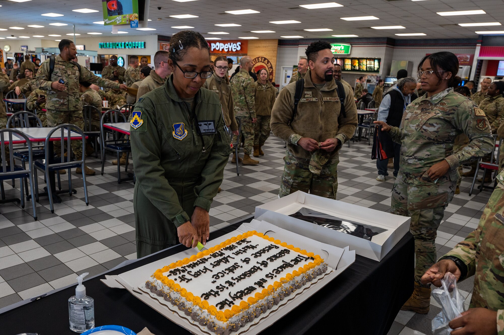 Col. Elizabeth Anderson-Doze cuts a cake celebrating Martin Luther King Jr. Day.