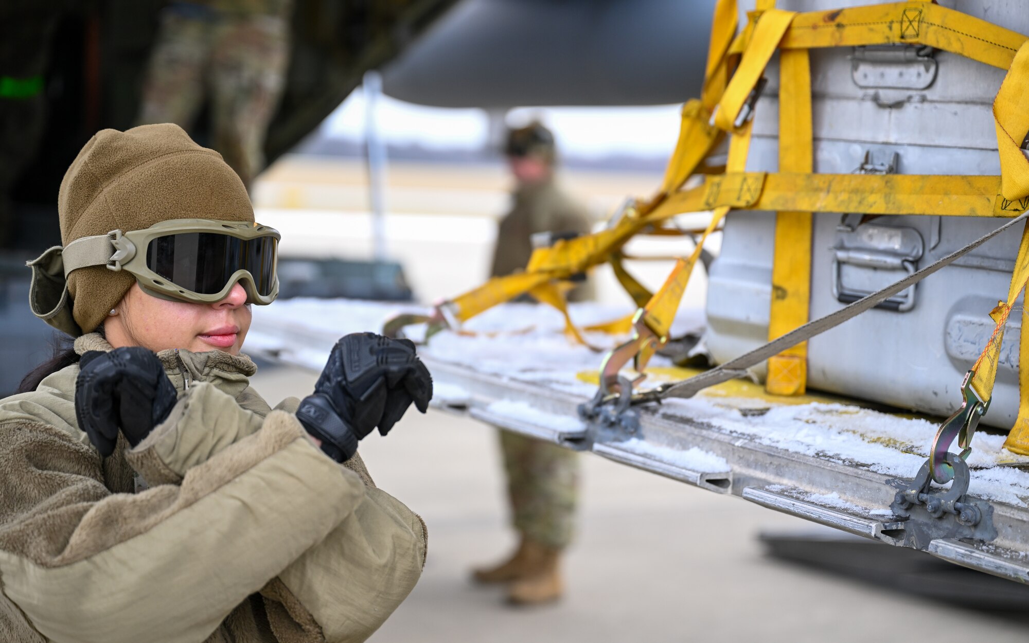 Staff Sgt. Miranda Petti, a port dawg with the 46th Aerial Port Squadron, Dover Air Force Base, Delaware, directs a pallet into the cargo bay of a C-130H Hercules aircraft stationed at Youngstown Air Reserve Station, Ohio, on Jan. 6, 2024.