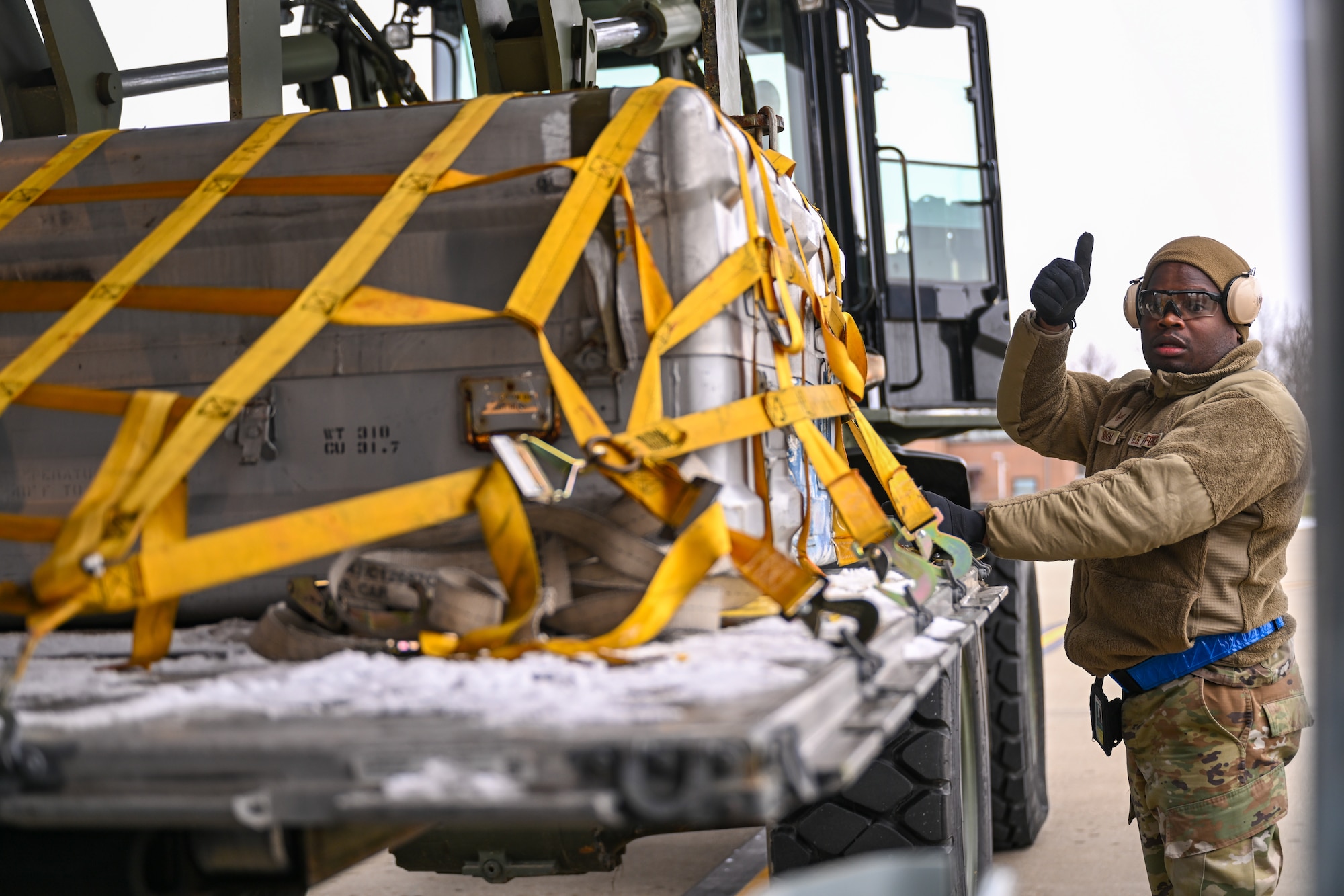 Staff Sgt. Rashawn Rahim, a port dawg with the 76th Aerial Port Squadron, directs a pallet into the cargo bay of a C-130H Hercules aircraft stationed at Youngstown Air Reserve Station, Ohio, on Jan. 6, 2024.