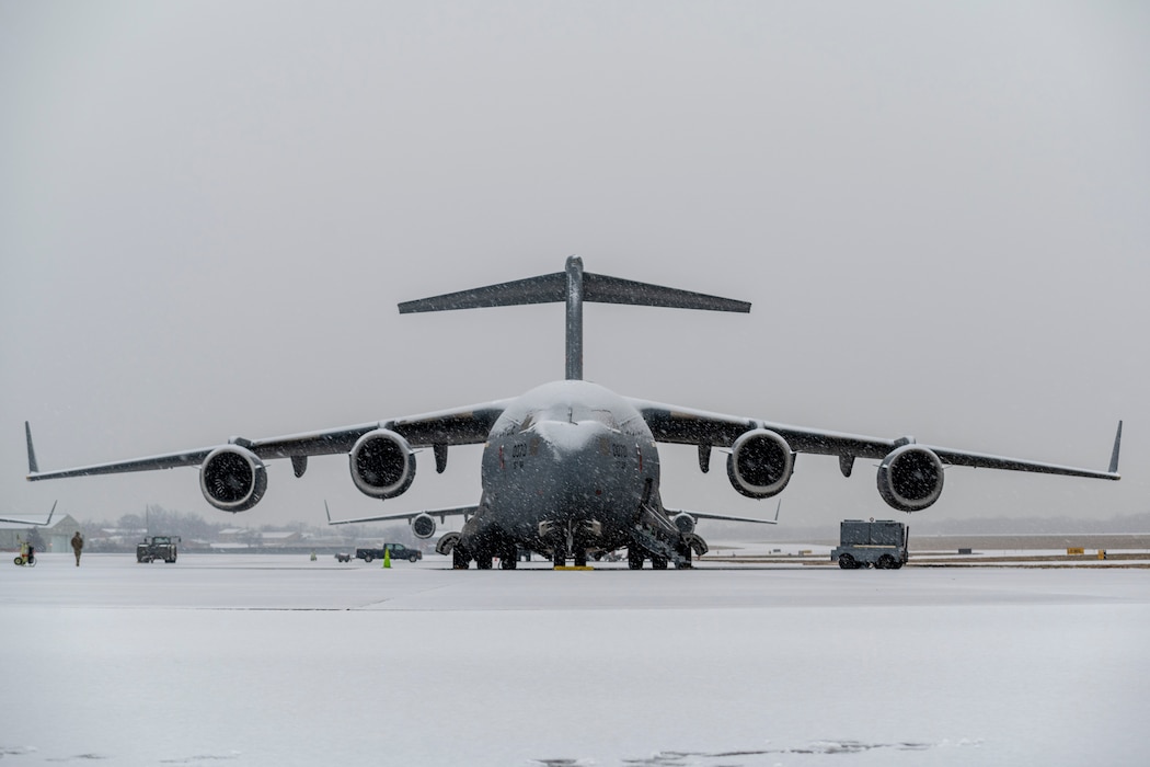 C-17 aircraft is parked on snow covered flight line