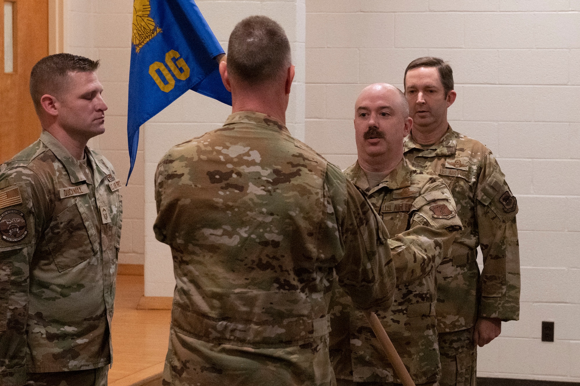 man is handed unit guidon from his commander