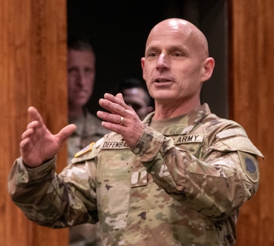 Newly promoted Chief Warrant Officer 5 Brandon Defenbaugh, of Athens, Illinois, the safety officer for the Illinois Army National Guard, thanks family and friends for their support during his more than 30 years of service during a promotion ceremony Jan. 11 at Camp Lincoln, Springfield, Illinois.