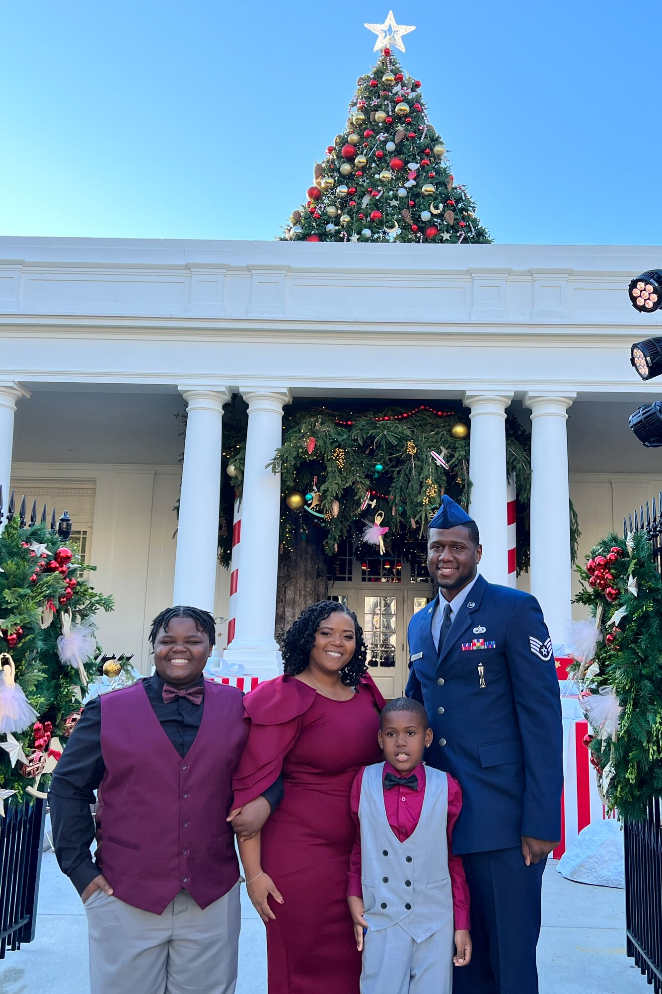 Four people standing in front of the White House.