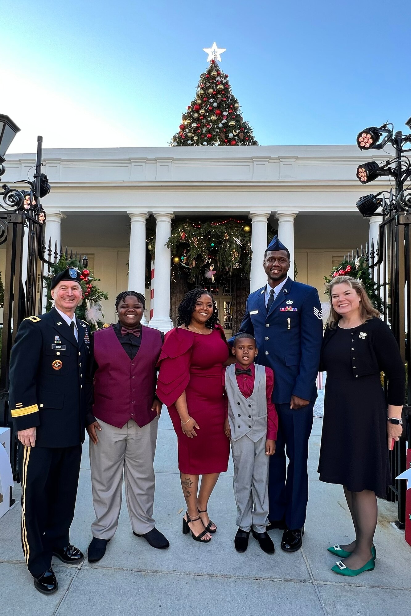 Six people standing in front of the White House.