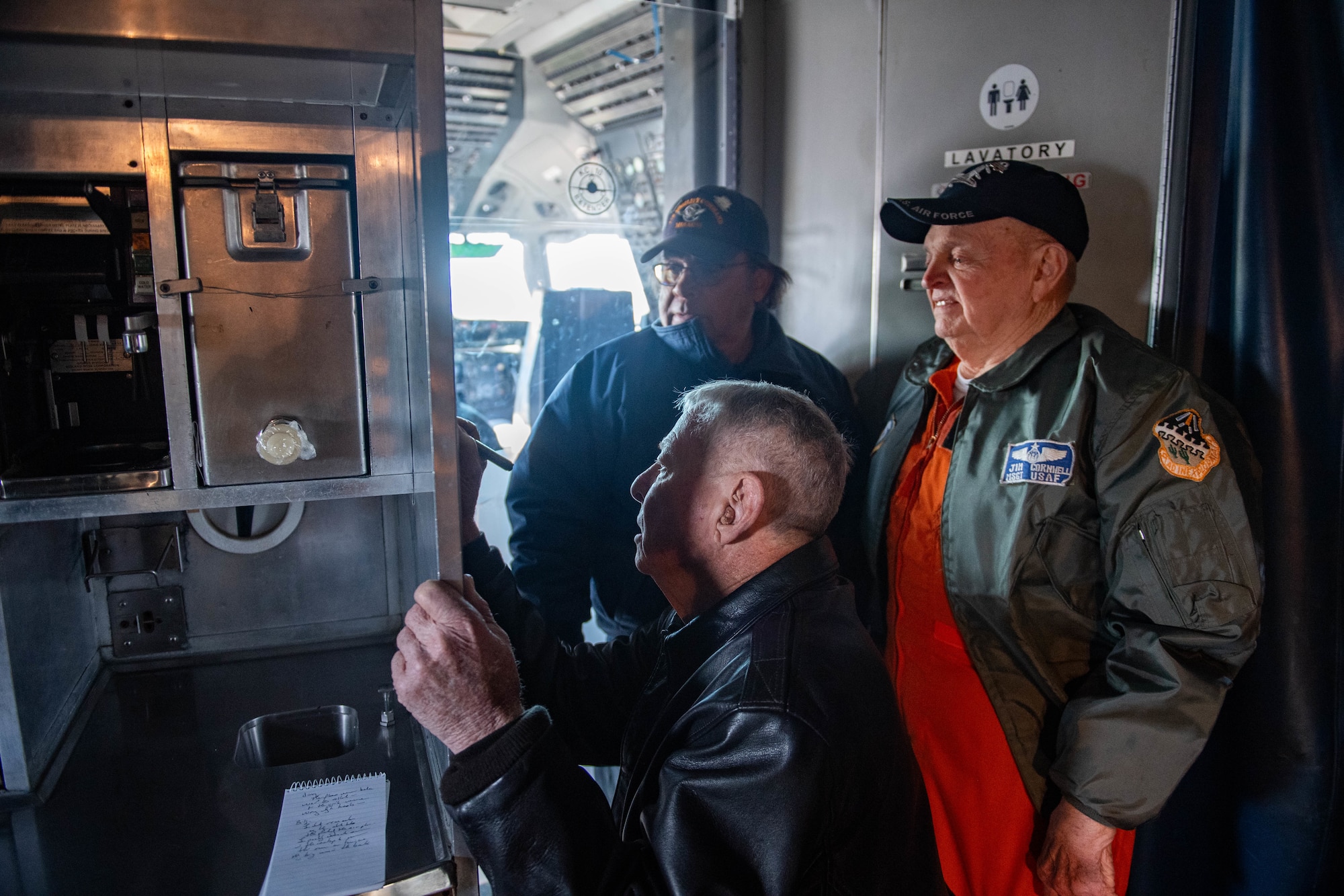 Retired U.S. Air Force Chief Master Sgt. Billy Meeks and Master Sgt. Jimmy Cronwell sign their names on KC-10A 79-0433 at Dover Air Force Base, Delaware, Dec. 12, 2023. Meeks and Cronwell were members of the flight test crew for the KC-10A 79-0433 as boom operators. Meeks and Cronwell were instrumental in establishing boom operations in the KC-10A. Tail number 79-0433 was the first of 60 KC-10A aircraft produced for the Air Force by McDonnell-Douglas and used primarily for aerial refueling. (U.S. Air Force photo by Tech. Sgt. J.D. Strong II)