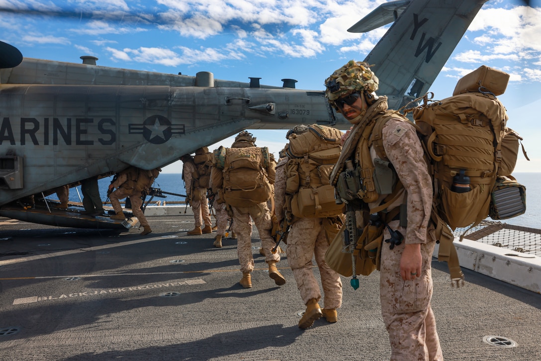 U.S. Marines assigned to Charlie Company, Battalion Landing Team 1/5, 15th Marine Expeditionary Unit, board a CH-53E Super Stallion attached to Marine Tiltrotor Squadron (VMM) 165 (Reinforced), 15th MEU, aboard the amphibious transport dock USS Somerset (LPD 25) in the Pacific Ocean, Dec. 18, 2023. The 15th MEU is currently embarked aboard the Boxer Amphibious Ready Group conducting integrated training and routine operations in U.S. 3rd Fleet. (U.S. Marine Corps photo by Cpl. Aidan Hekker)