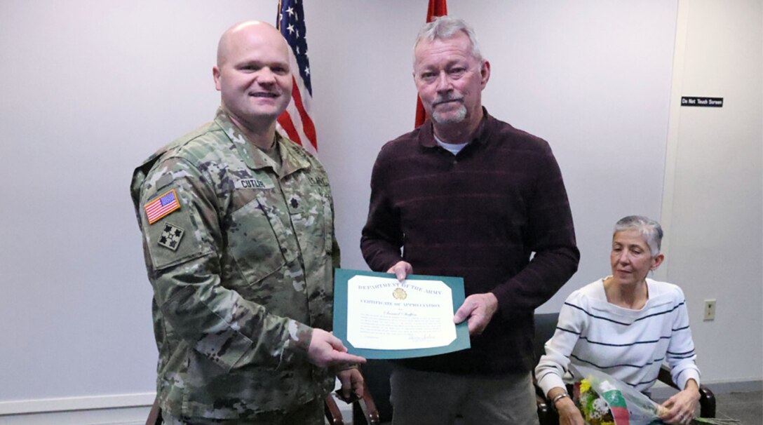 Samuel Staffan, U.S. Army Corps of Engineers, Mobile District transportation/fleet manager, receives his retirement certificate from Lt. Col. Gary Cutler, Mobile District Deputy Commander, during a ceremony in Mobile, Alabama, Jan. 4, 2024. Staffan retired after 47 years of federal service, which included 22 years as  a U.S. Navy Seabee. (U.S. Army photo by Chuck Walker)