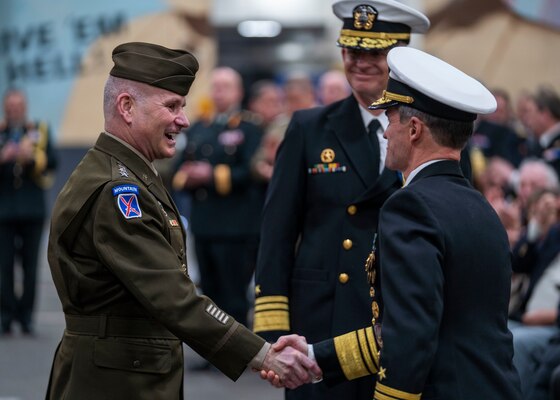 Vice Adm. Doug Perry, right shakes hands with NATO’s Supreme Allied Commander Europe, Gen. Christopher G. Cavoli after assuming command of Joint Force Command Norfolk during a change of command ceremony aboard USS Harry S. Truman (CVN 75).