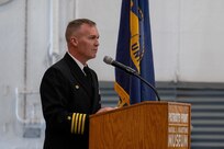 A photo of a man at a podium.