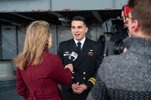 A photo of a man being interviewed.