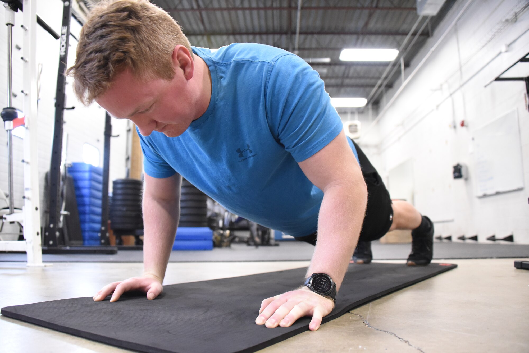 U.S. Air National Guard Technical Sgt. Devon Parr, a 185th Air Refueling Wing aerospace propulsion technician, demonstrates a pushup