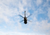 A UH-60 lifts off with simulated patients on Dec. 7, 2023, at Joint Base San Antonio-Camp Bullis, Texas, during Operation AGILE Medic. The joint exercise equipped medics with training in various austere environments, both on-ground and in-air. (U.S. Air Force photo by Senior Airman Melody Bordeaux)