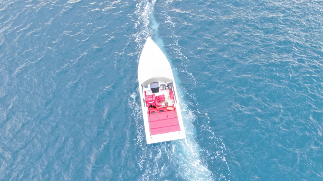 Coast Guard MH-60T Jayhawk aircrew flies over empty 30-foot white power boat during search for missing boater near Coki Point in St. Thomas, U.S. Virgin Islands, Jan. 14, 2024.  Coast Guard air and surface crews continue the search for Todman Davaughn, 51, who reportedly was the sole person aboard the vessel when he was ejected after crashing and spinning out of control several times. (U.S. Coast Guard photo)