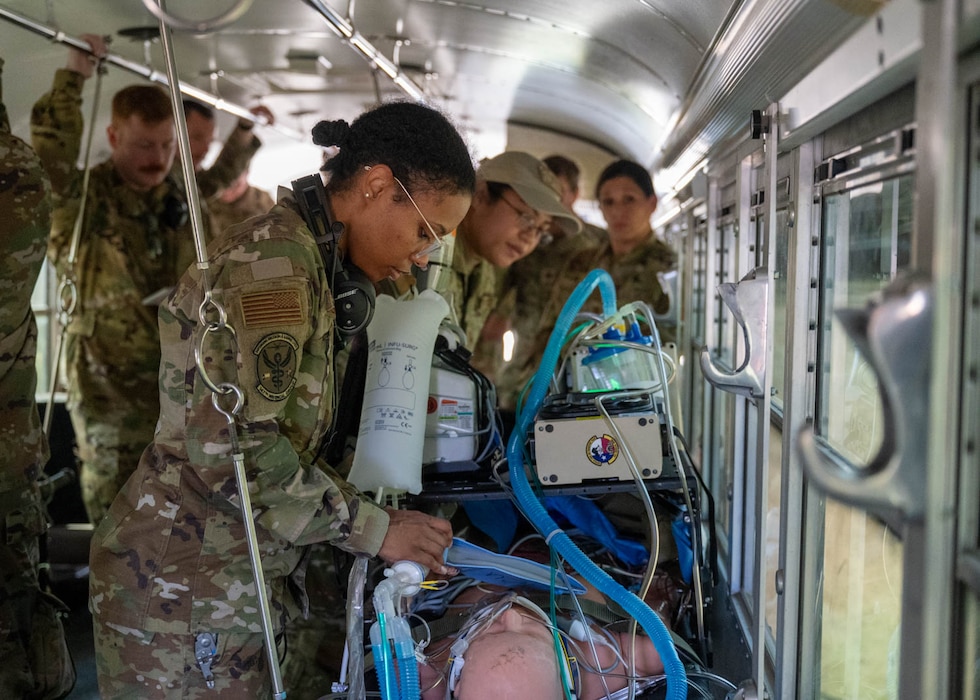 Airmen care for simulated patients on the way to an aircraft on Dec. 6, 2023, at Joint Base San Antonio-Camp Bullis, Texas, during Operation AGILE Medic. This joint force medical training exercise involves hands-on scenarios in an austere environment, providing medics with crucial experience in communication and diverse medical skills. (U.S. Air Force photo by Senior Airman Melody Bordeaux)