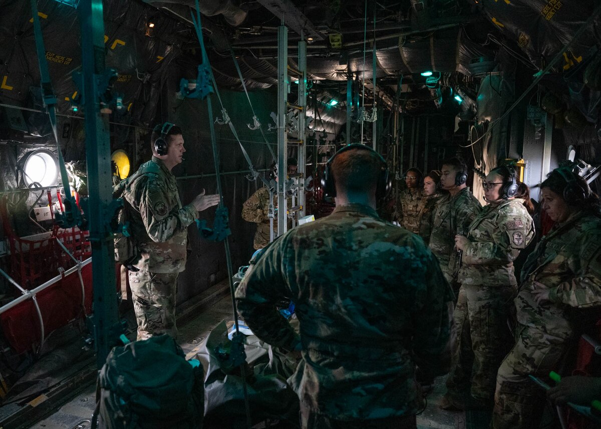 Airmen in the Critical Care Air Transport Team discuss patient care on Dec. 6, 2023, at Joint Base San Antonio-Camp Bullis, Texas, during Operation AGILE Medic. This joint force medical training exercise immerses medics in the seamless process of transporting patients from the Expeditionary Medical Support unit to the En Route Patient Staging System team, and onwards to Air Evacuation and Critical Care Air Transport Teams, and vice versa. The hands-on experience ensures medics gain a comprehensive understanding of communication protocols, the critical timing for patient preparation, and the intricacies of the entire process. (U.S. Air Force photo by Senior Airman Melody Bordeaux)