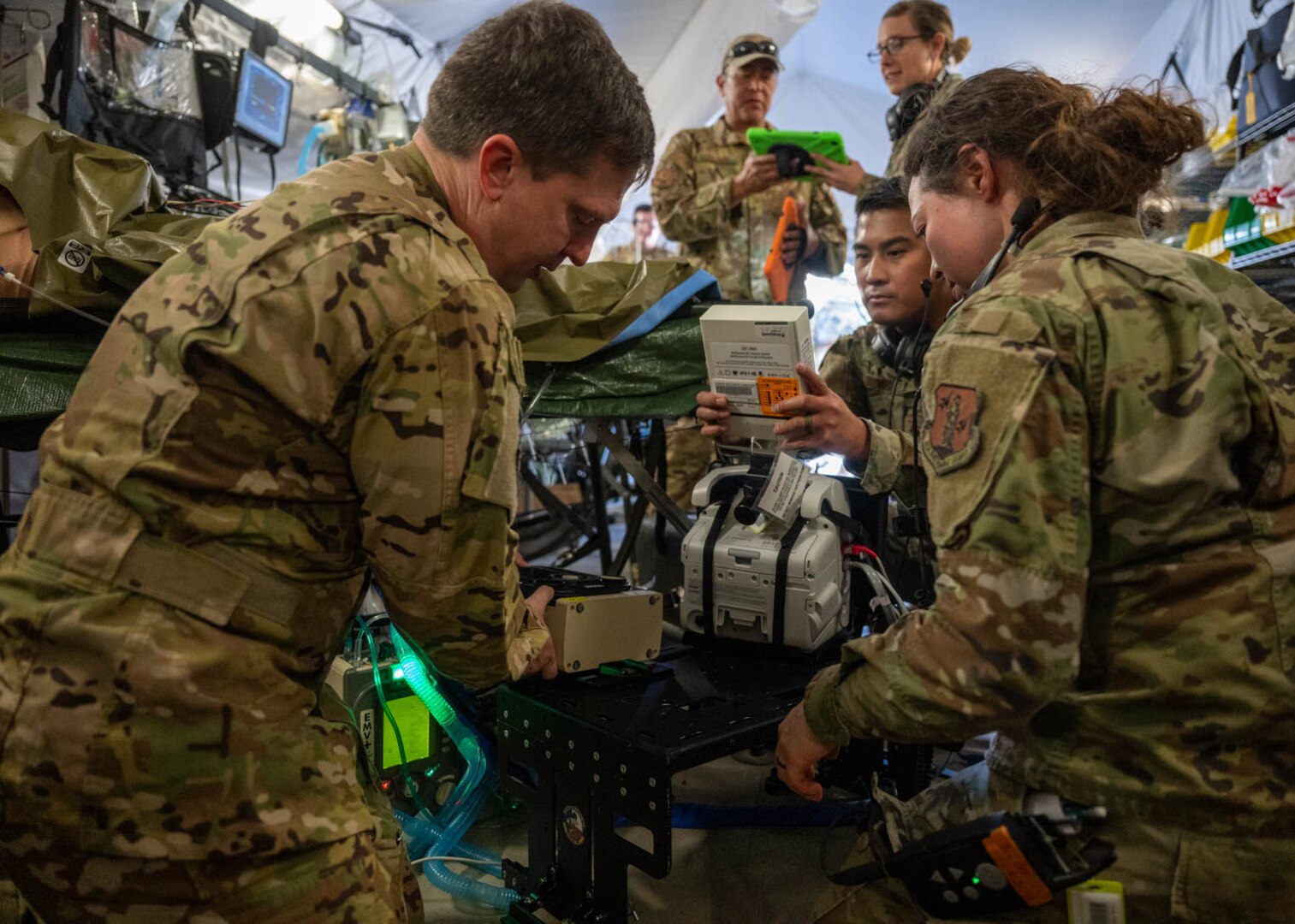 Airmen in the Critical Care Air Transport Team prepare a simulated patient for transfer on Dec. 6, 2023, at Joint Base San Antonio-Camp Bullis, Texas, during Operation AGILE Medic. The joint force exercise equipped medics with training in austere environments and limited resources, fostering readiness for diverse scenarios where they may need to provide patient care while efficiently managing resources. (U.S. Air Force photo by Senior Airman Melody Bordeaux)