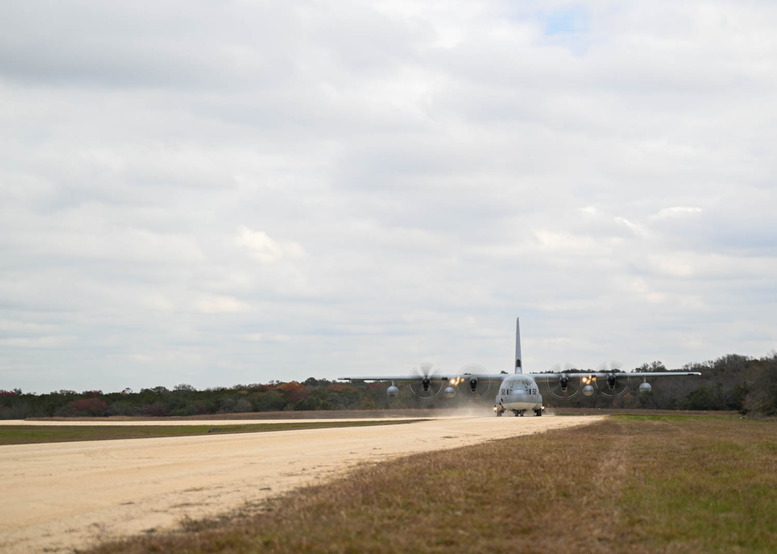 A C-130 lands with simulated patients on Dec. 7, 2023, at Joint Base San Antonio-Camp Bullis, Texas, during Operation AGILE Medic. Active duty and reserve Air Force, Air National Guard, Army Reserve and Marines all collaborated in the joint force medical training exercise and equipped medics with training in various austere environments, both on-ground and in-air. (U.S. Air Force photo by Senior Airman Melody Bordeaux)