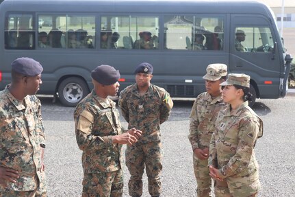 Sgt. Maj. Esmeralda Vaquerano, G-1 (personnel) Sergeant Major for the D.C. Army National Guard and Sgt. Jessica A. Frazer, Recruitment and Retention Battalion, D.C. Army National Guard are briefed by members of the Jamaica Defence Force (JDF) during a State Partnership Program visit to the Caribbean Military Academy (CMA), Dec. 12-14, 2023. D.C. Guard members participated in an NCO Career Development Subject Matter Expert Exchange (SMEE) which included reviewing training, promotions, leadership, duties and responsibilities of NCOs with JDF’s Jamaica Regiment, Support Brigade, and the Martitime, Air and Cyber Command (MACC).