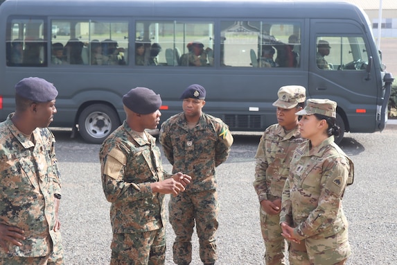 Sgt. Maj. Esmeralda Vaquerano, G-1 (personnel) Sergeant Major for the D.C. Army National Guard and Sgt. Jessica A. Frazer, Recruitment and Retention Battalion, D.C. Army National Guard are briefed by members of the Jamaica Defence Force (JDF) during a State Partnership Program visit to the Caribbean Military Academy (CMA), Dec. 12-14, 2023. D.C. Guard members participated in an NCO Career Development Subject Matter Expert Exchange (SMEE) which included reviewing training, promotions, leadership, duties and responsibilities of NCOs with JDF’s Jamaica Regiment, Support Brigade, and the Martitime, Air and Cyber Command (MACC).