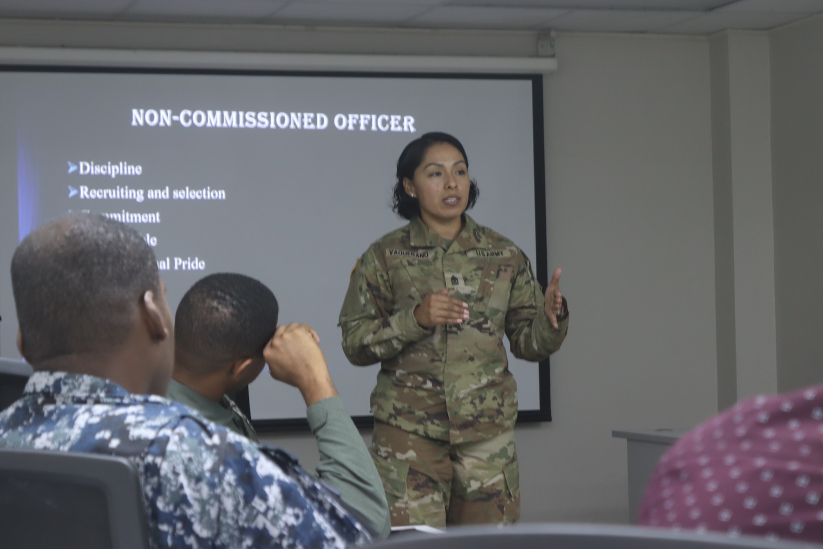 Sgt. Maj. Esmeralda Vaquerano, G-1 (personnel) Sergeant Major for the D.C. Army National Guard recites the U.S. Army’s NCO Creed to members of the Jamaica Defence Force (JDF) during a State Partnership Program visit to the Caribbean Military Academy (CMA), Dec. 12-14, 2023. D.C. Guard members participated in an NCO Career Development Subject Matter Expert Exchange (SMEE) which included reviewing training, promotions, leadership, duties and responsibilities of NCOs with JDF’s Jamaica Regiment, Support Brigade, and the Martitime, Air and Cyber Command (MACC).