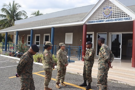 Sgt. Maj. Esmeralda Vaquerano, G-1 (personnel) Sergeant Major for the D.C. Army National Guard and Sgt. Jessica A. Frazer, Recruitment and Retention Battalion, D.C. Army National Guard are briefed by members of the Jamaica Defence Force (JDF) during a State Partnership Program visit to the Caribbean Military Academy (CMA), Dec. 12-14, 2023. D.C. Guard members participated in an NCO Career Development Subject Matter Expert Exchange (SMEE) which included reviewing training, promotions, leadership, duties and responsibilities of NCOs with JDF’s Jamaica Regiment, Support Brigade, and the Martitime, Air and Cyber Command (MACC).