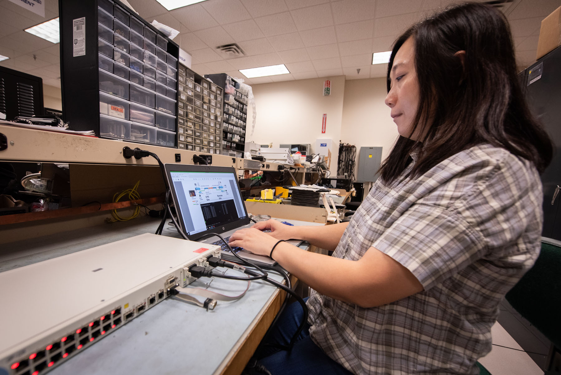 Photo of a NIWC Atlantic Employee configuring a system for use in the ATC.