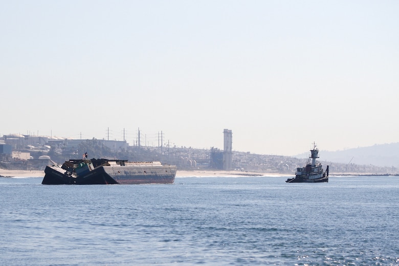 The Seana C, at right, a triple-screw-model bow tug, pulls a dump scow, called the Robert L, on the way to deposit dredged material near the shore of Dockweiler State Beach in Playa del Rey, California. The pair of vessels is slated to make four to five trips per day for the next five months.
