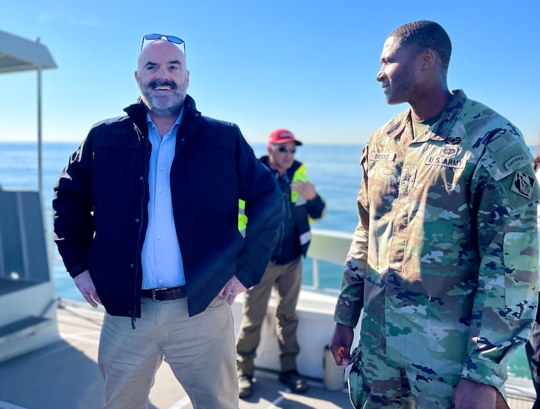 Lt. Col. Stephen Brooks, U.S. Army Corps of Engineers Los Angeles District deputy commander, right, talks with Gary Jones, director of the Los Angeles County Department of Beaches and Harbors, during a Jan. 9 boat tour of dredging operations at Marina del Rey Harbor in LA County, California. Brooks spent most of the day visiting with LA District project-delivery team members and LA County project partners to better understand how he can best support those working on the project.